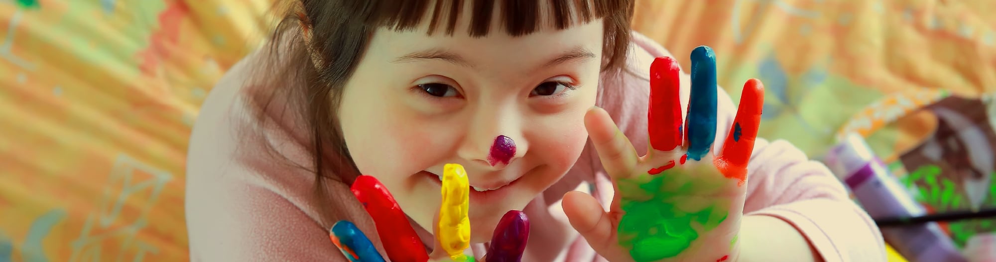 Happy girl with paint on her fingers
