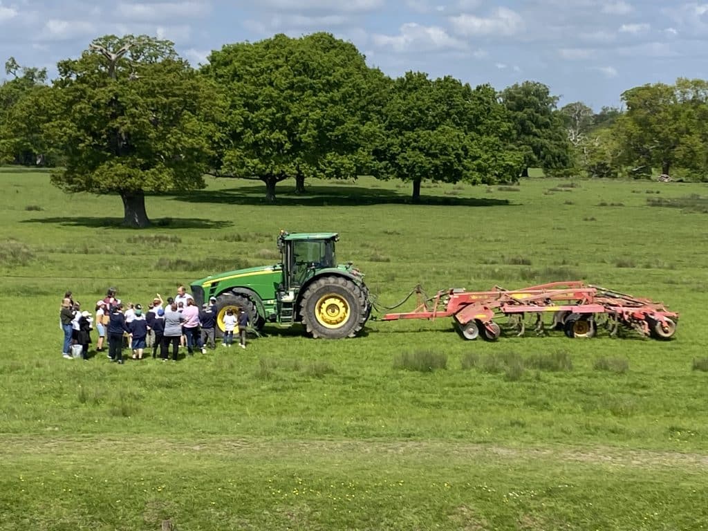 Group of people standing next to a tractor