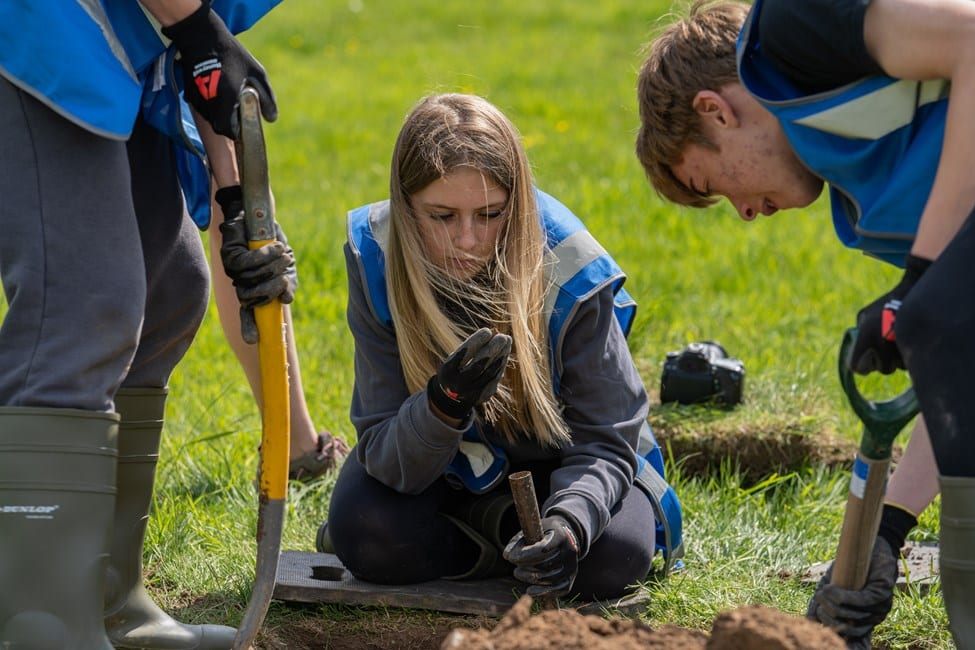 Young adults excavating some ground
